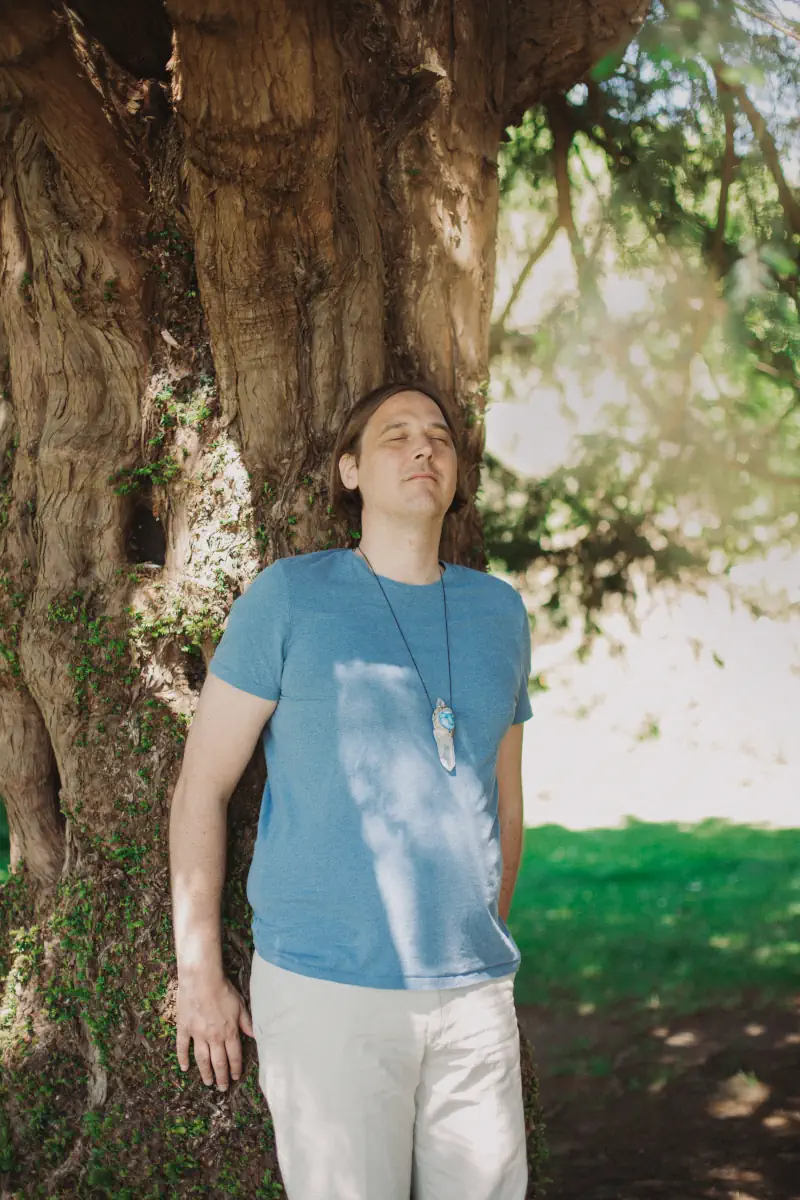 Michiel Kroon leaning against ancient tree in Glastonbury - Starseed Guide