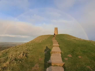 Exploring Starseed connection with nature at Glastonbury Tor with Rainbow above it