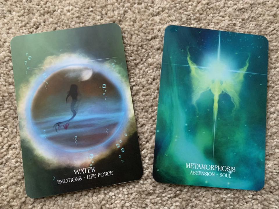 Two oracle cards showing water and metamorphosis, reflecting emotions, change, and returning to kindness as an inner home